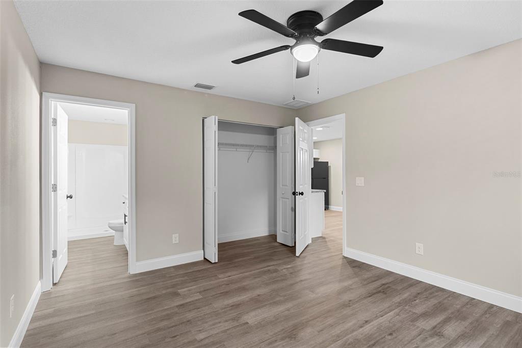 603 Moose Lodge Road, Unit A Bartow, FL 33830 - Photo 32 of 45 an empty room with wooden floor and ceiling fan
