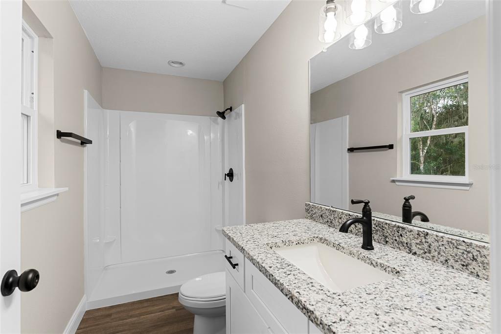 603 Moose Lodge Road, Unit A Bartow, FL 33830 - Photo 33 of 45 a bathroom with a granite countertop sink toilet and shower