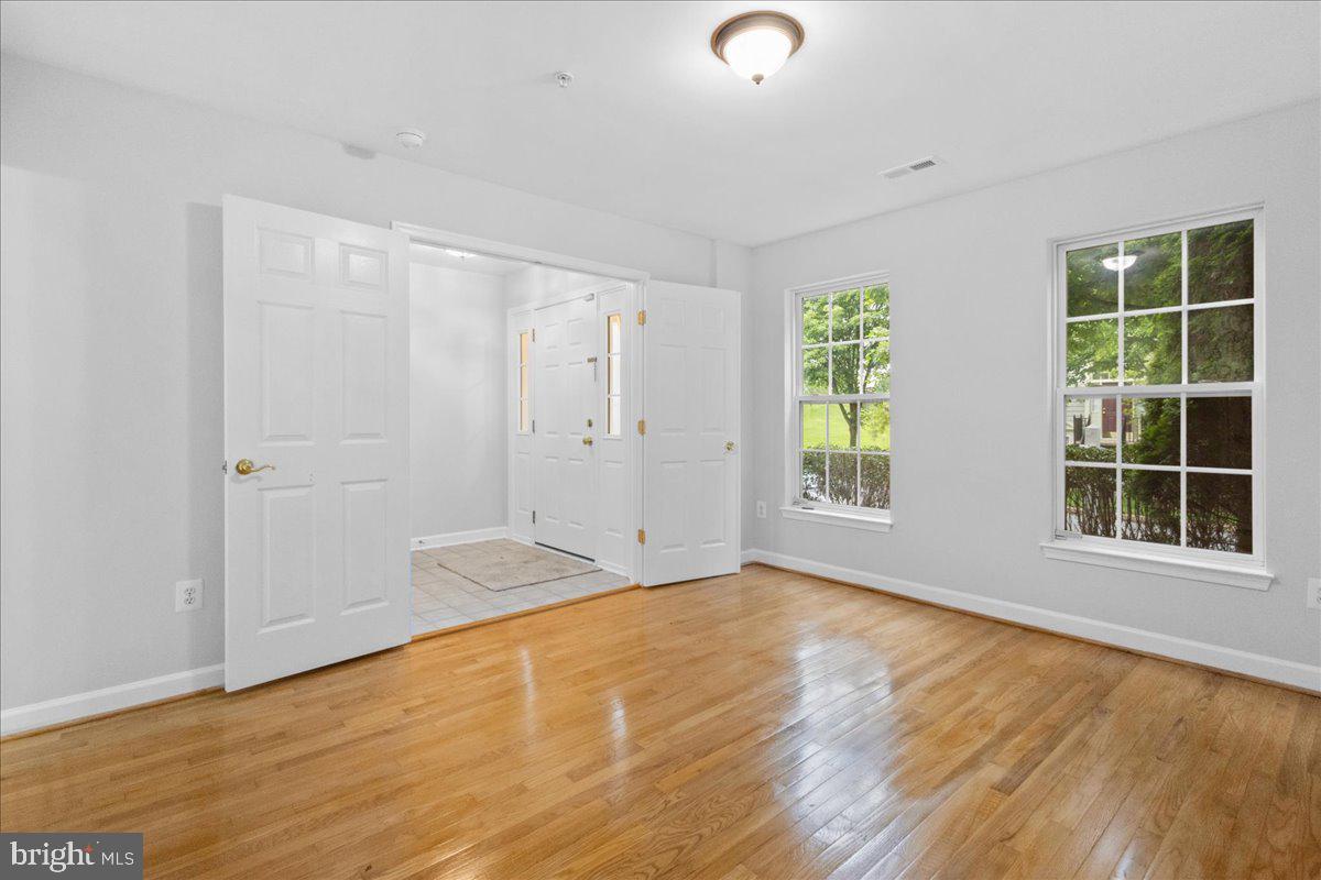 3618 Sprigg Street South Frederick, MD 21704 - Photo 12 of 37 a view of an empty room with wooden floor and a window