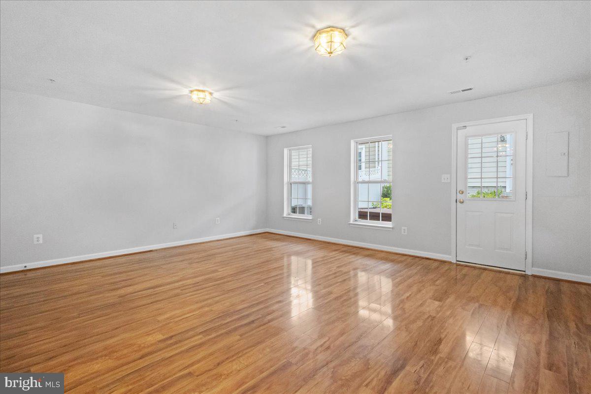 3618 Sprigg Street South Frederick, MD 21704 - Photo 14 of 37 an empty room with wooden floor and windows