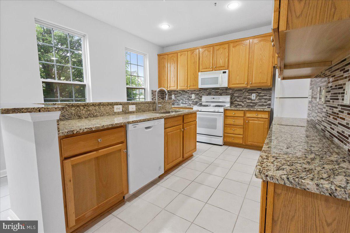 3618 Sprigg Street South Frederick, MD 21704 - Photo 25 of 37 a kitchen with stainless steel appliances granite countertop a sink stove and cabinets