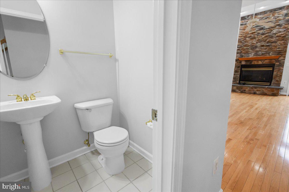 3618 Sprigg Street South Frederick, MD 21704 - Photo 27 of 37 a white toilet sitting next to a bathroom sink and a mirror
