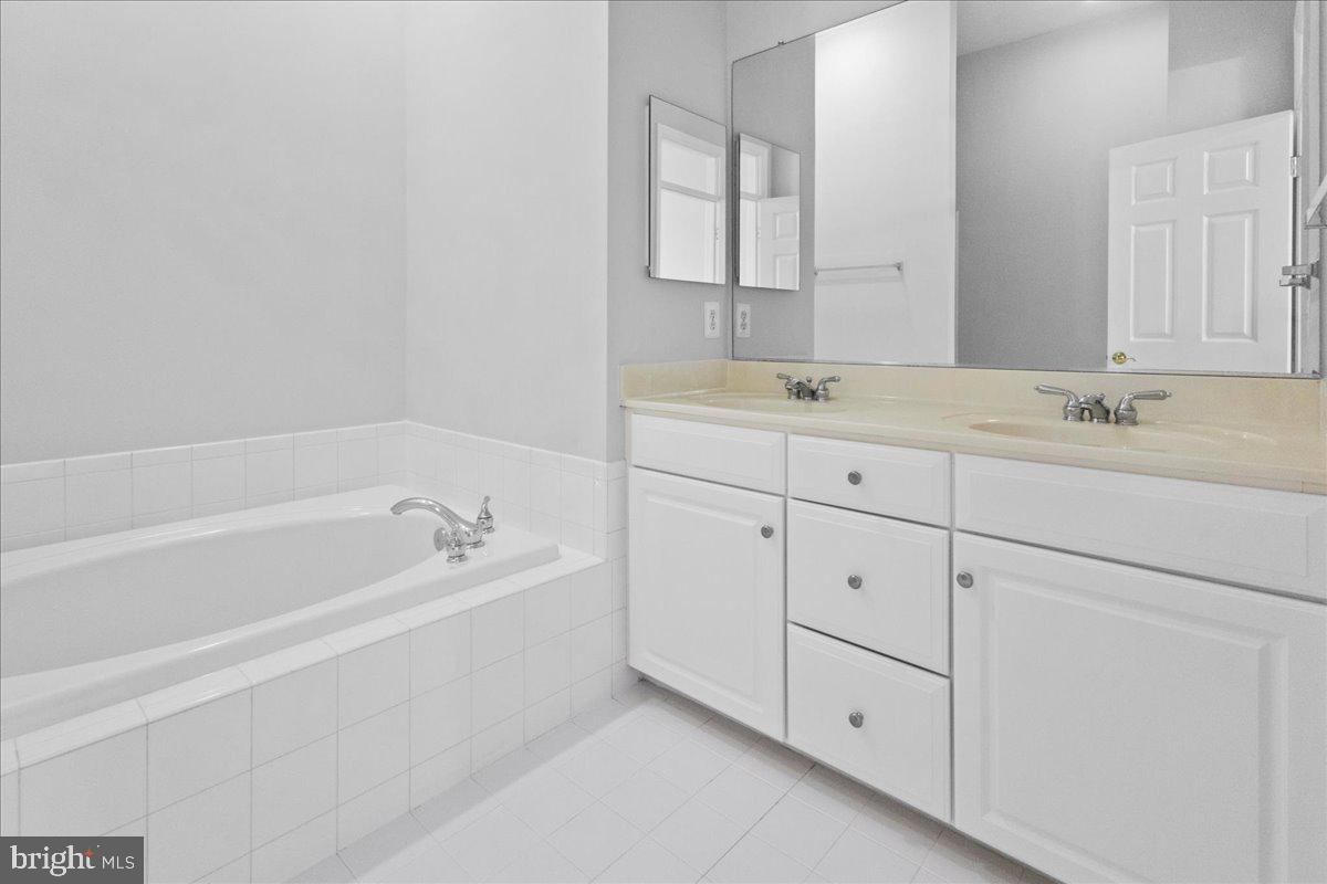 3618 Sprigg Street South Frederick, MD 21704 - Photo 32 of 37 a bathroom with a tub sink and mirror