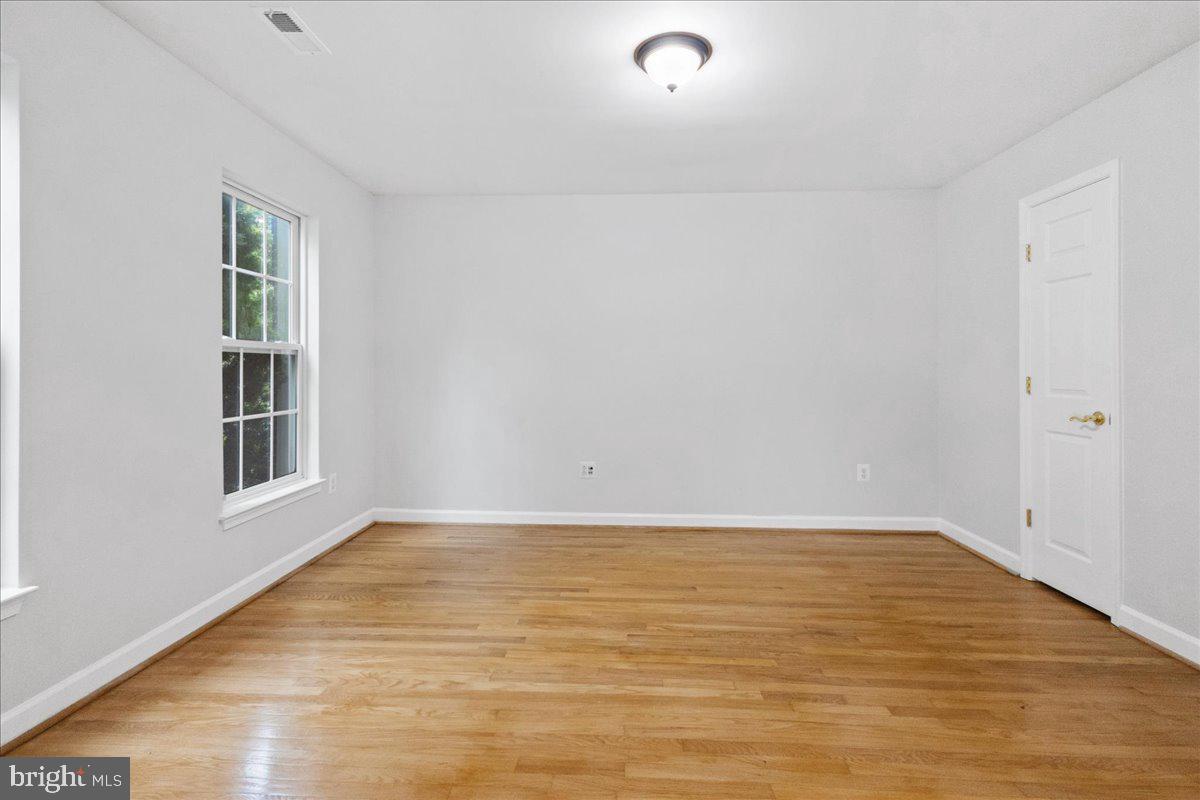 3618 Sprigg Street South Frederick, MD 21704 - Photo 10 of 37 a view of an empty room with wooden floor and a window