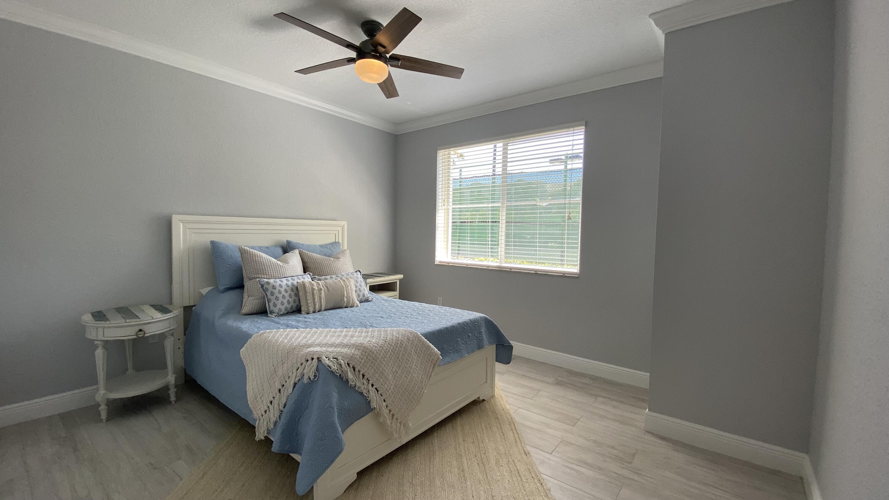 11024 Legacy Drive, Unit 104 Palm Beach Gardens, FL 33410 - Photo 16 of 26 a bedroom with a bed and a window