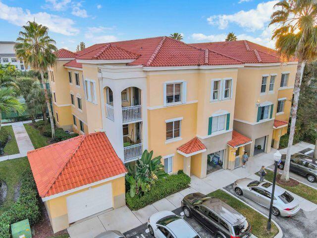 11024 Legacy Drive, Unit 104 Palm Beach Gardens, FL 33410 - Photo 20 of 26 a view of a patio with couches table and chairs and potted plants