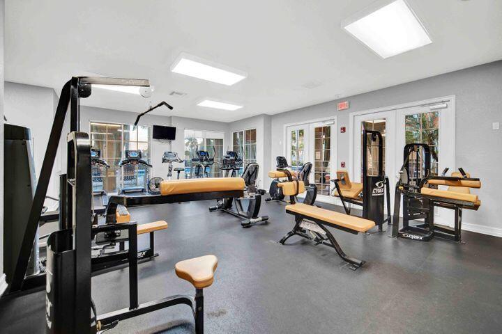 11024 Legacy Drive, Unit 104 Palm Beach Gardens, FL 33410 - Photo 22 of 26 a living room with furniture and a flat screen tv