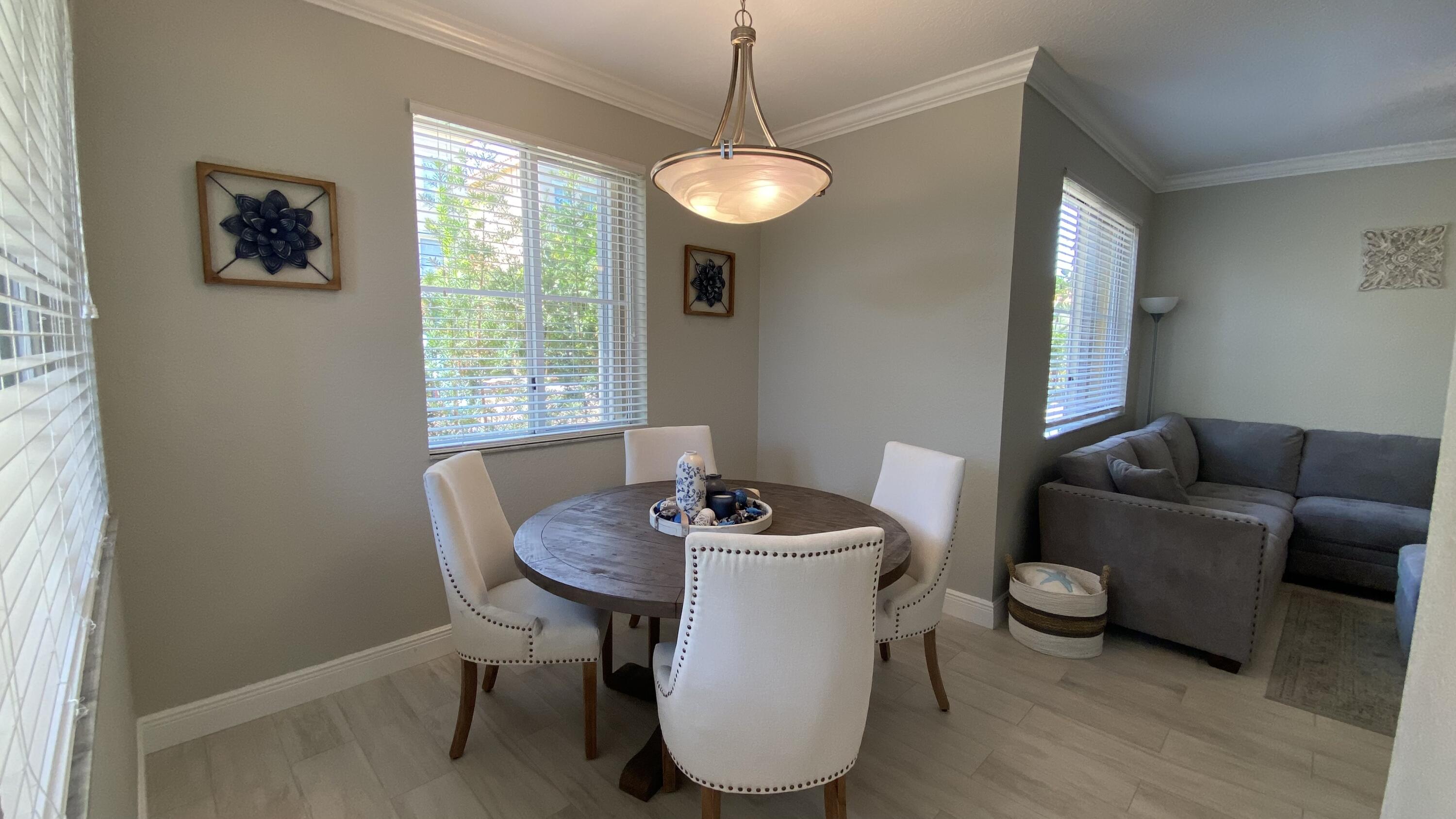 11024 Legacy Drive, Unit 104 Palm Beach Gardens, FL 33410 - Photo 6 of 26 a dining room with furniture and window