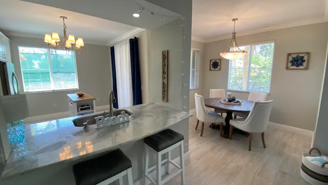 a dining room with furniture a chandelier and window