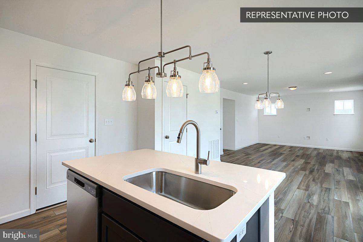 Sassafras Plan At Hills Spring Grove, PA 17362 - Photo 16 of 33 a kitchen with a sink and a refrigerator