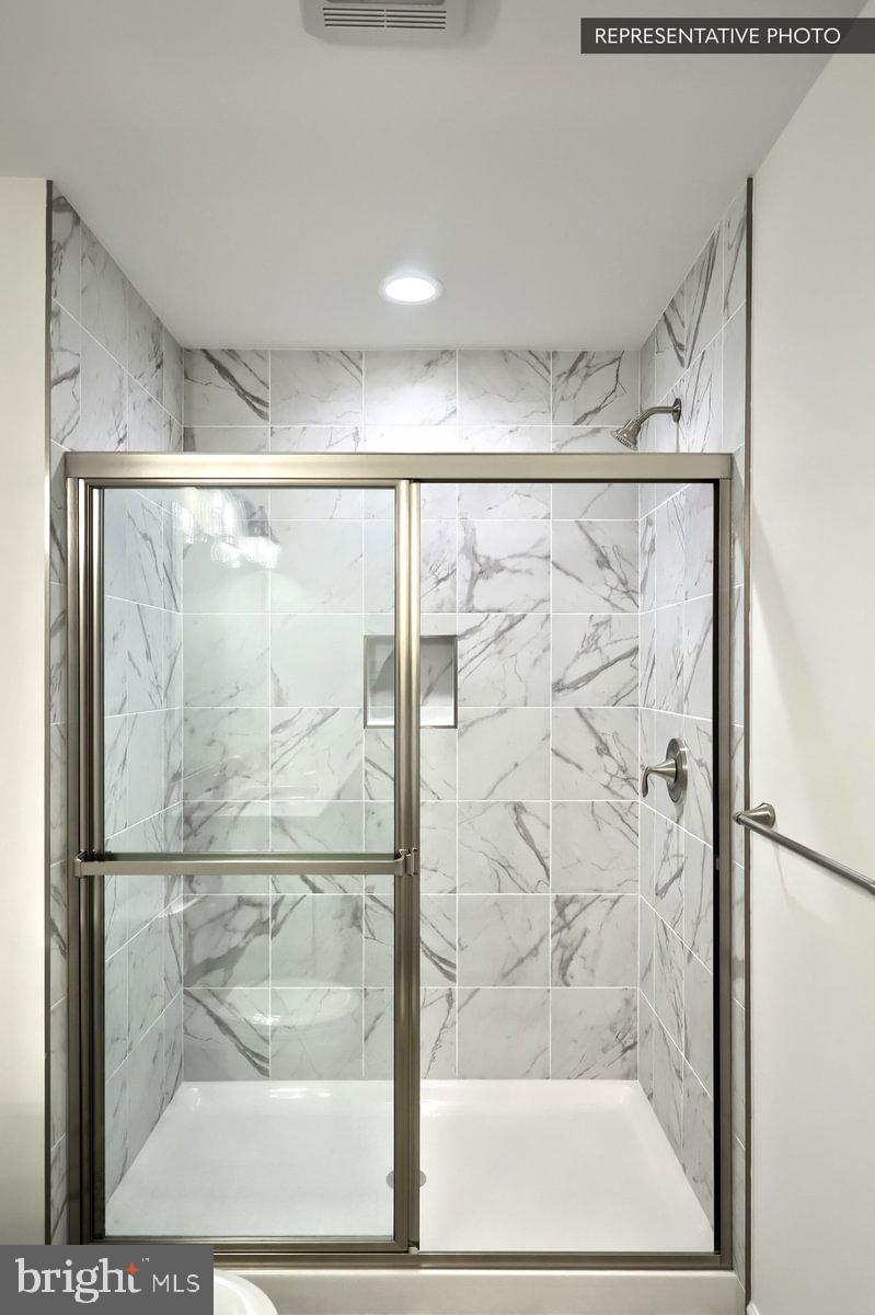 Sassafras Plan At Hills Spring Grove, PA 17362 - Photo 24 of 33 a bathroom with a glass shower door