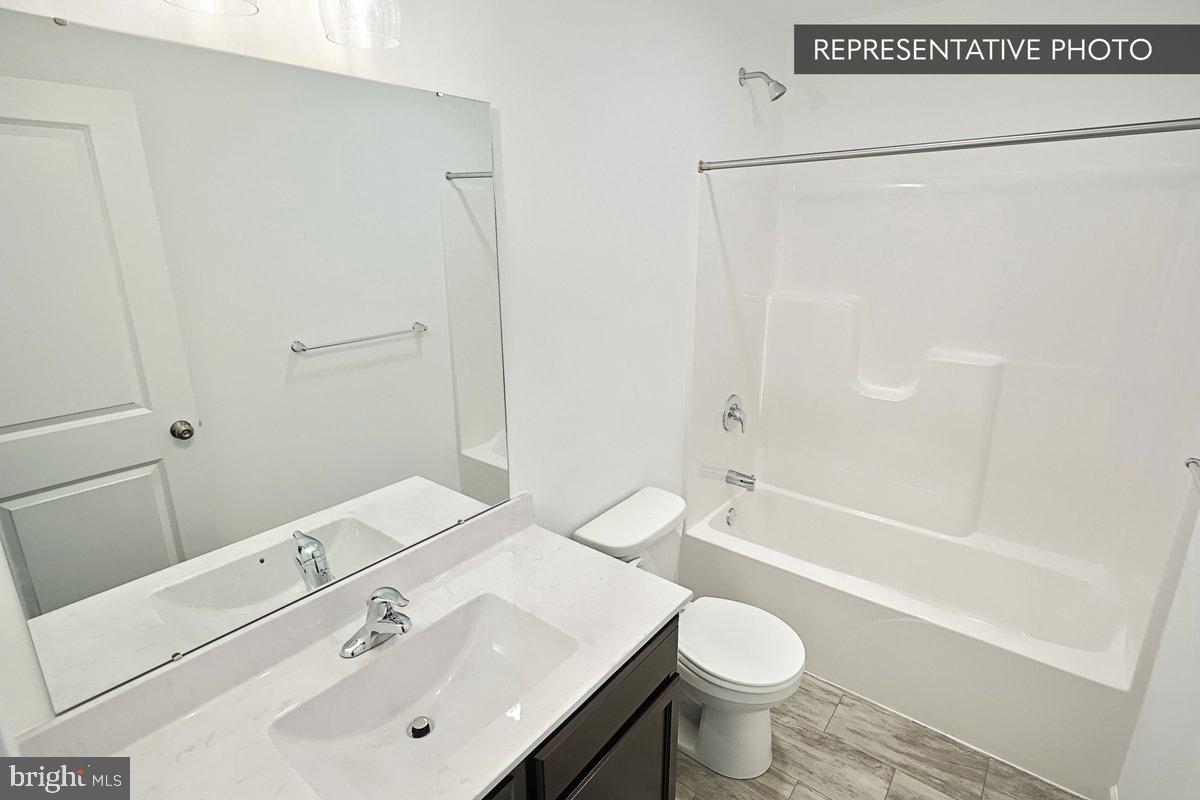 Sassafras Plan At Hills Spring Grove, PA 17362 - Photo 32 of 33 a bathroom with a sink toilet and shower