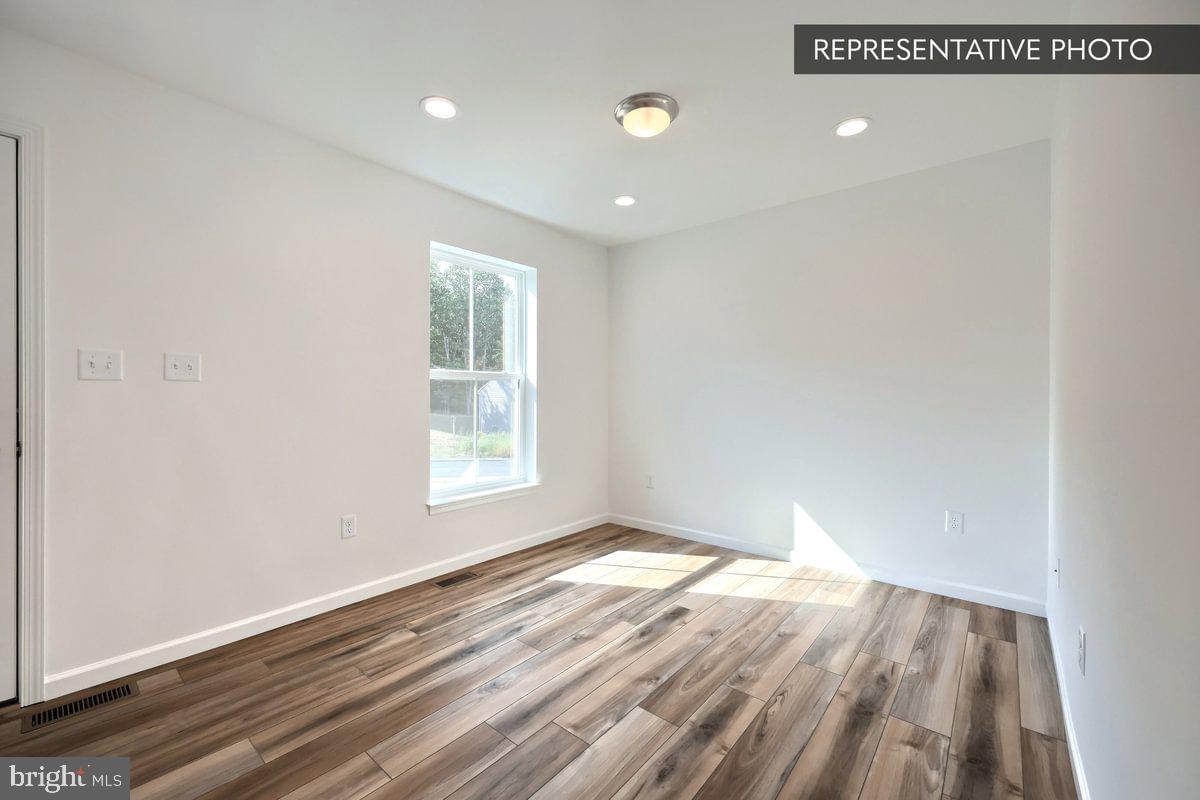 Sassafras Plan At Hills Spring Grove, PA 17362 - Photo 6 of 33 a view of an empty room with wooden floor and a window