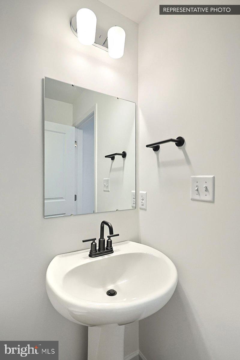 Sassafras Plan At Hills Spring Grove, PA 17362 - Photo 7 of 33 a bathroom with a sink and mirror