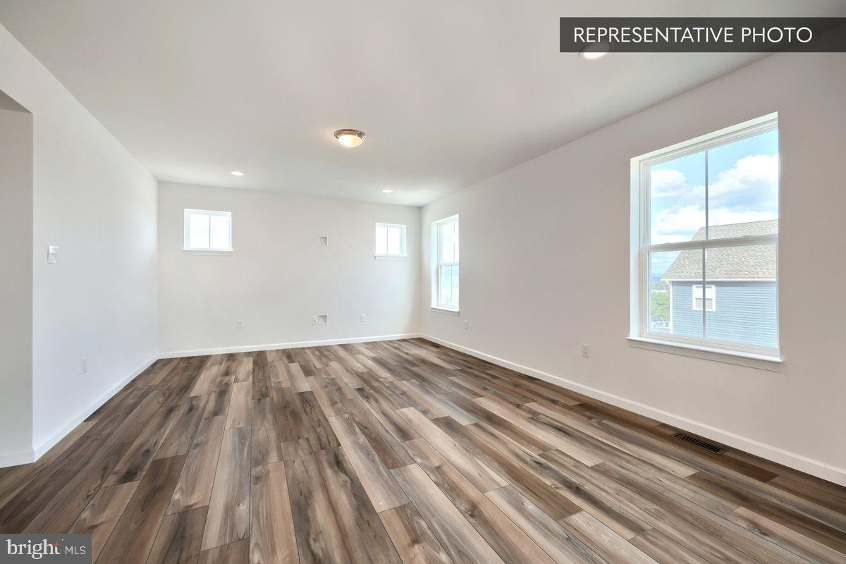 Sassafras Plan At Hills Spring Grove, PA 17362 - Photo 8 of 33 an empty room with wooden floor and windows