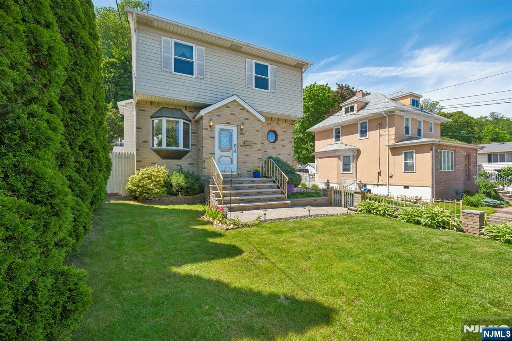 562 Valley Road Clifton, NJ 07013 - Photo 3 of 35 a front view of a house with a yard and garage