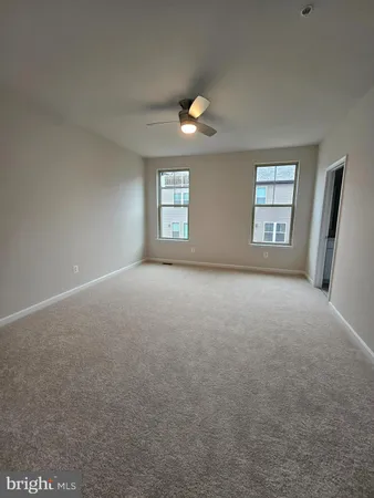 an empty room with windows and closet