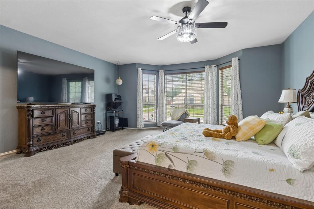 129 Timberbluff Lane Murphy, TX 75094 - Photo 18 of 34 a bedroom with a bed and a flat screen television