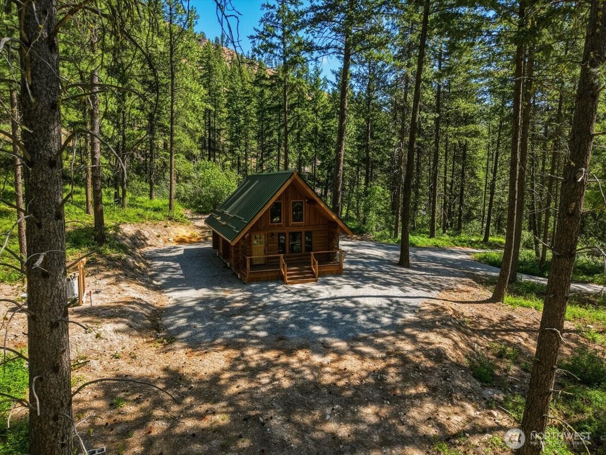 2350 First Crk Road Chelan, WA 98816 - Photo 5 of 39 a wooden house with trees in the background