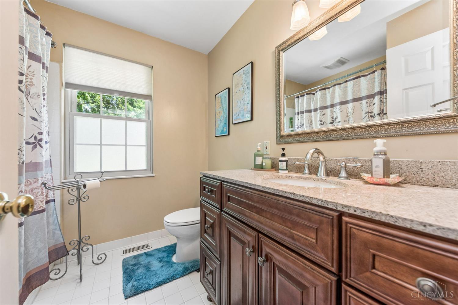 6400 Roth Ridge Drive Loveland, OH 45140 - Photo 26 of 40 Spacious hall bath is updated w/newer vanity and granite countertops.
