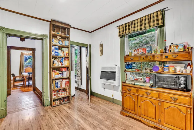 a living room with stainless steel appliances furniture and a large window