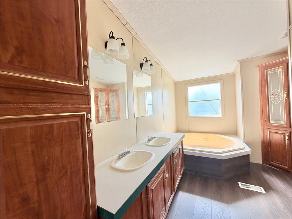 9721 Limestone Joshua, TX 76058 - Photo 21 of 36 a bathroom with a sink a bathtub and a window