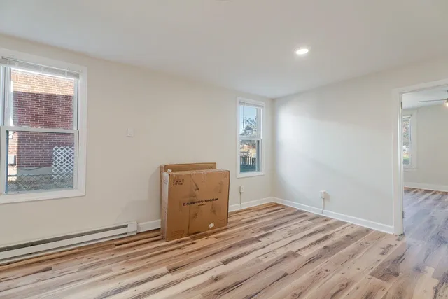 a view of room with window and hardwood floor