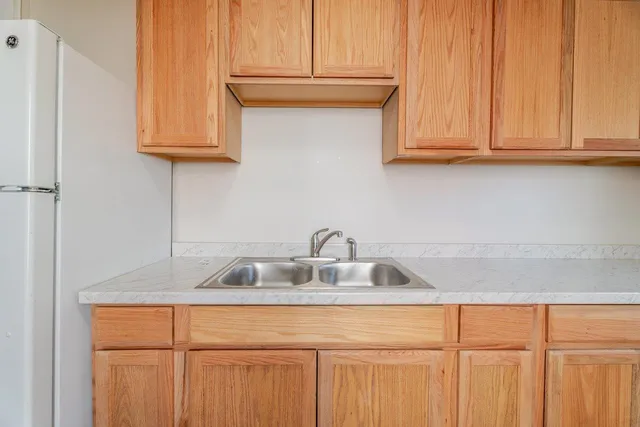 a kitchen with stainless steel appliances granite countertop white cabinets and a sink