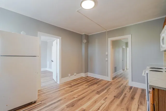 a view of a room with wooden floor
