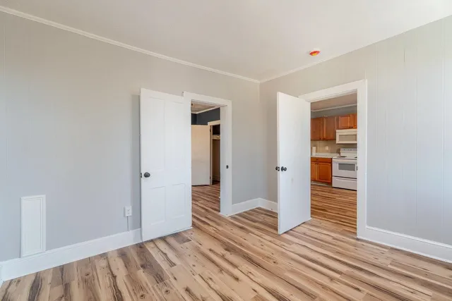 a view of a livingroom with a ceiling fan and wooden floor