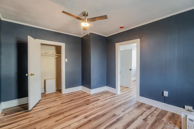 a view of empty room with wooden floor