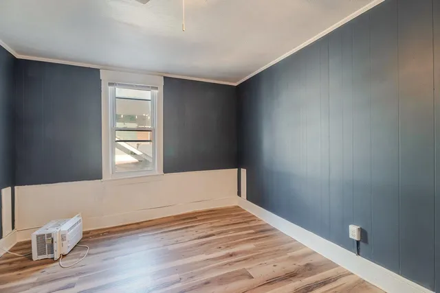 a bedroom with bed and window