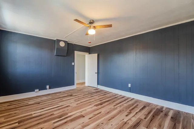 a bath room with a toilet a bath tub and a window