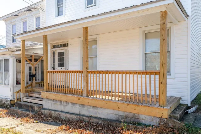 a view of a balcony with wooden floor and fence