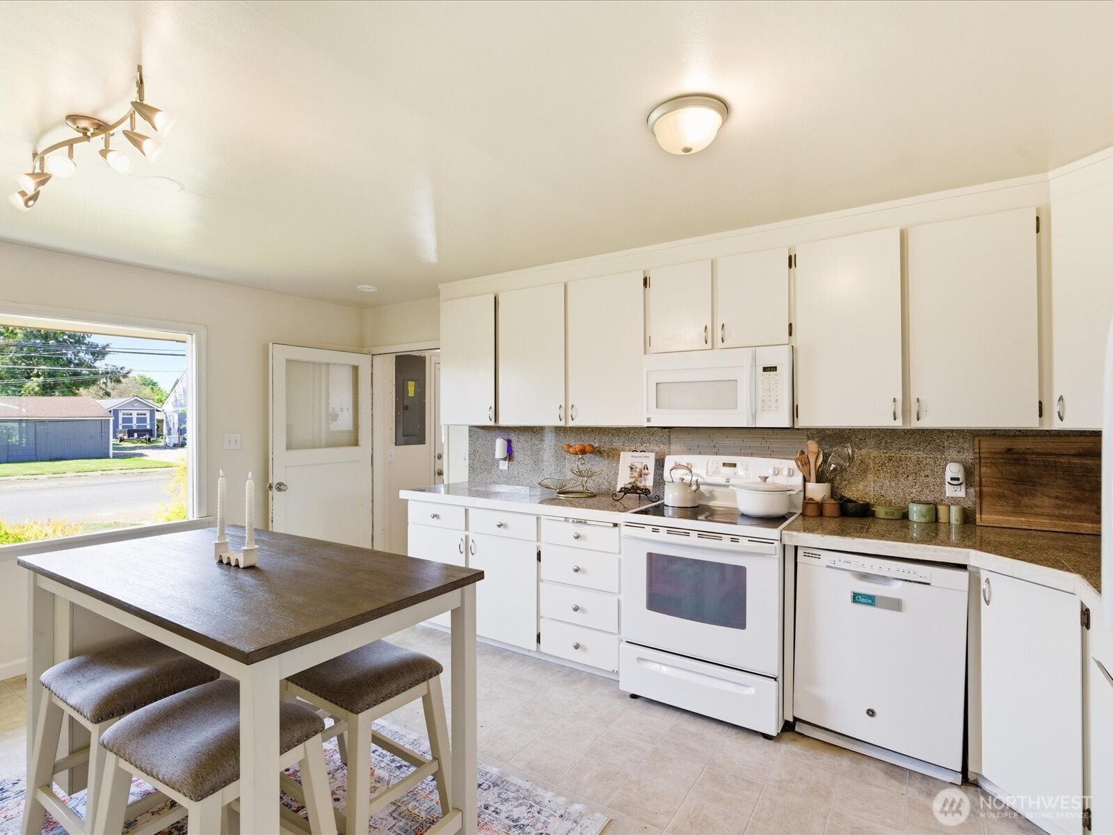 1417 Maple Street Sumner, WA 98390 - Photo 25 of 40 a kitchen with a sink and cabinets