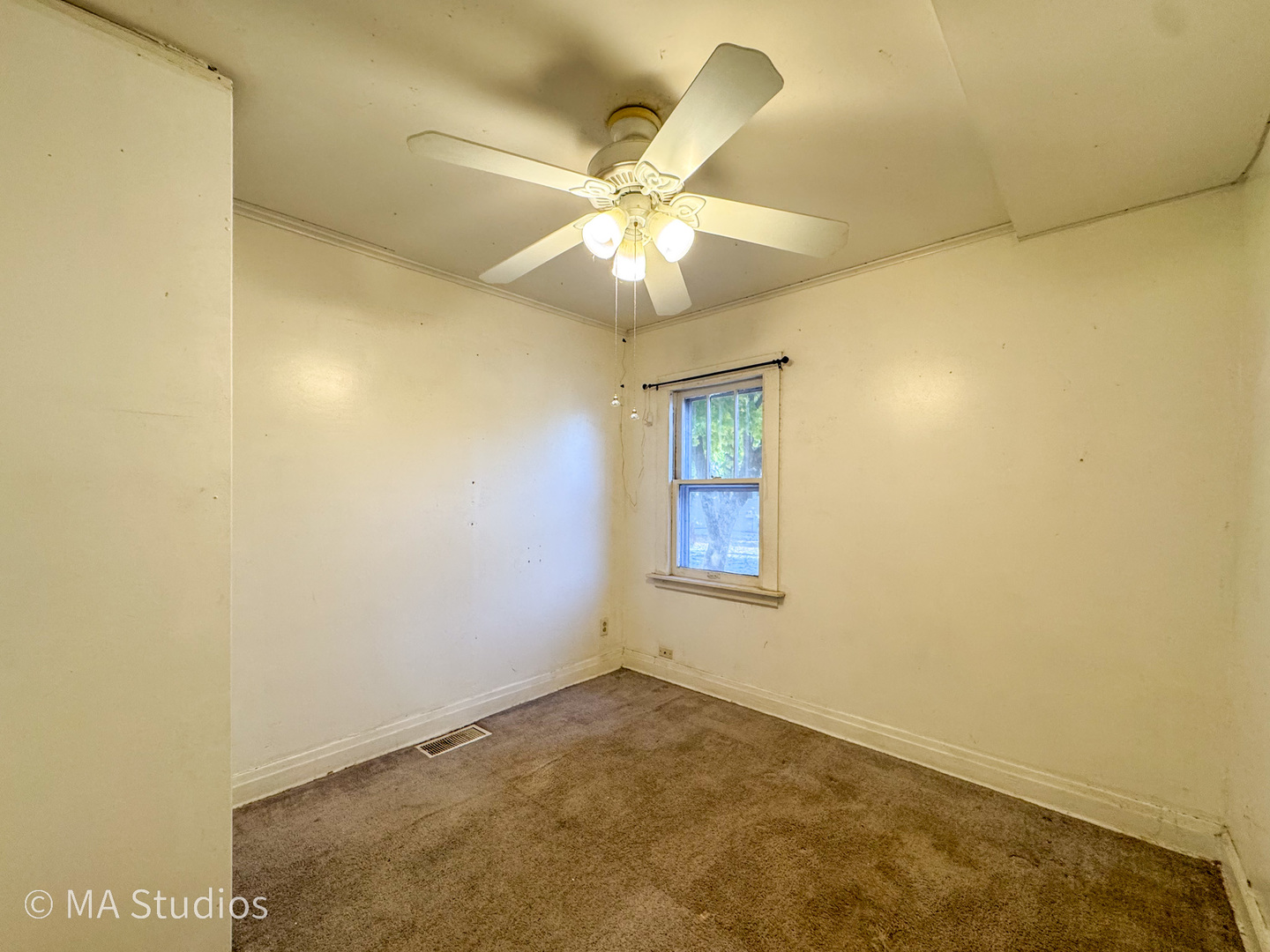 8-s057 South Vine Street Burr Ridge, IL 60527 - Photo 11 of 37 an empty room with a chandelier fan and windows