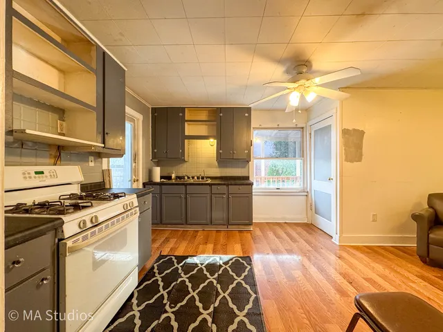 a kitchen with stainless steel appliances granite countertop a stove a sink and a refrigerator
