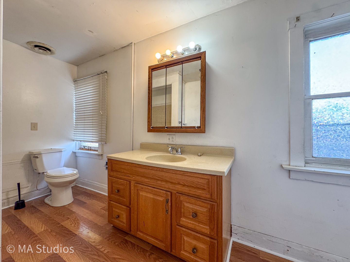 8-s057 South Vine Street Burr Ridge, IL 60527 - Photo 19 of 37 a bathroom with a toilet sink and mirror