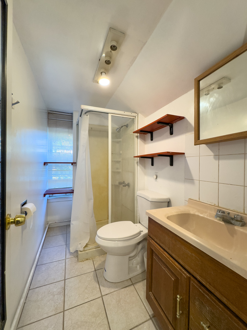 8-s057 South Vine Street Burr Ridge, IL 60527 - Photo 22 of 37 a bathroom with a sink toilet and shower