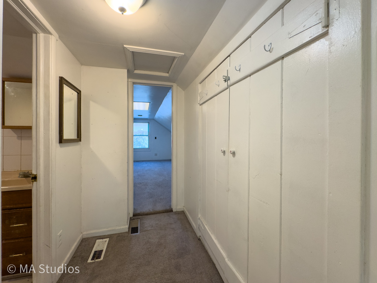 8-s057 South Vine Street Burr Ridge, IL 60527 - Photo 24 of 37 a view of a hallway with wooden cabinets