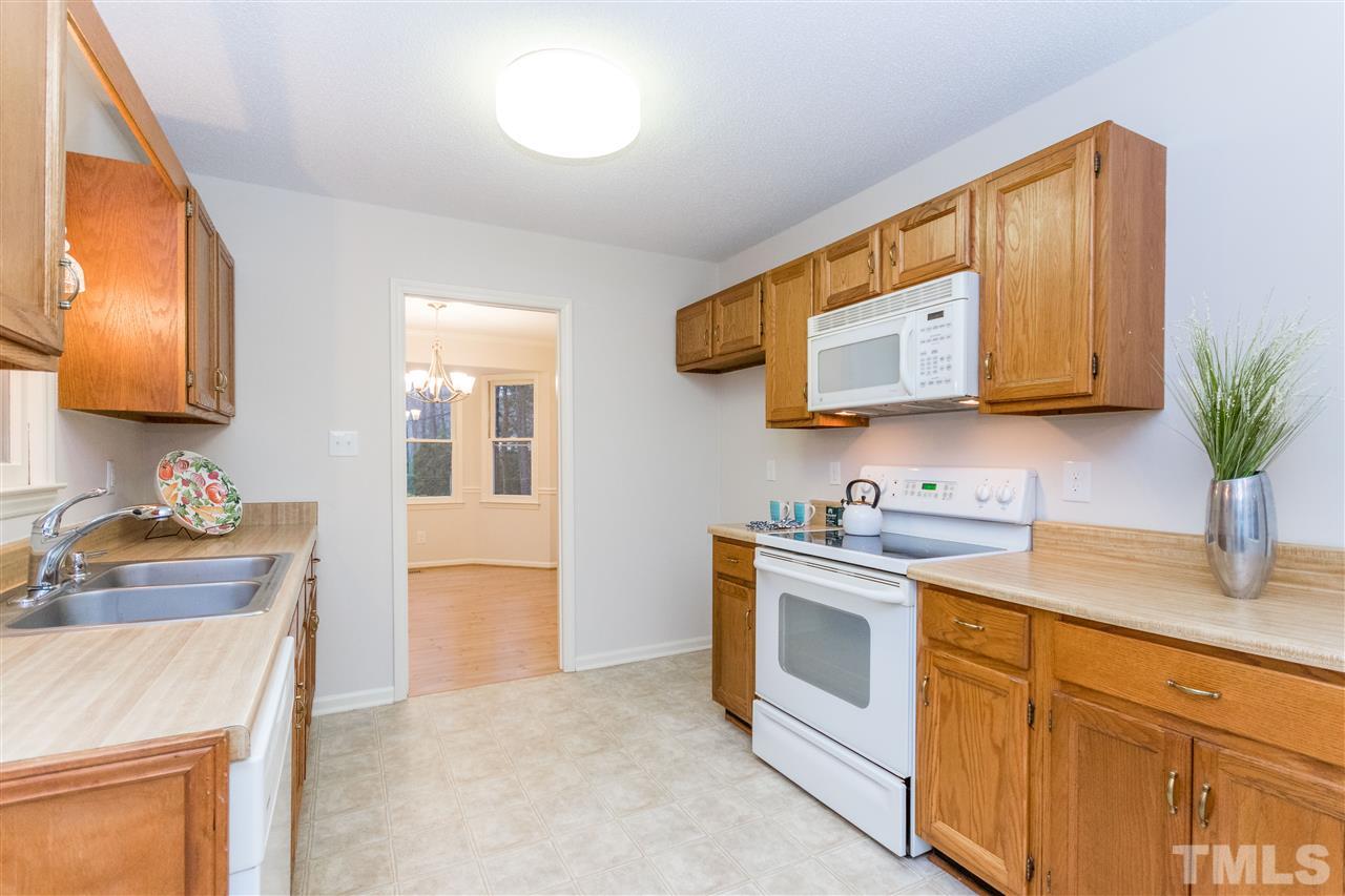 8300 Dunwood Court Raleigh, NC 27613 - Photo 2 of 18 a kitchen with stainless steel appliances granite countertop a sink and a stove top oven