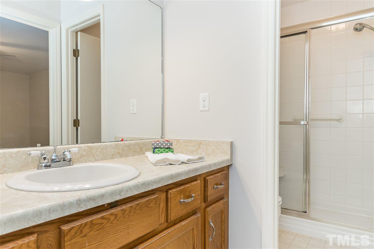 8300 Dunwood Court Raleigh, NC 27613 - Photo 15 of 18 a bathroom with a sink and a mirror