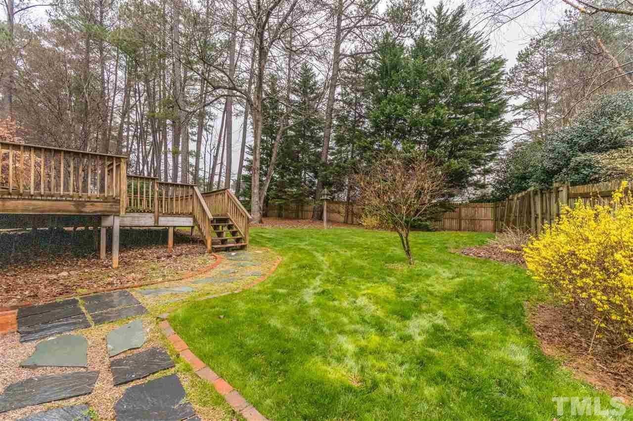 8300 Dunwood Court Raleigh, NC 27613 - Photo 16 of 18 a view of a backyard with a slide