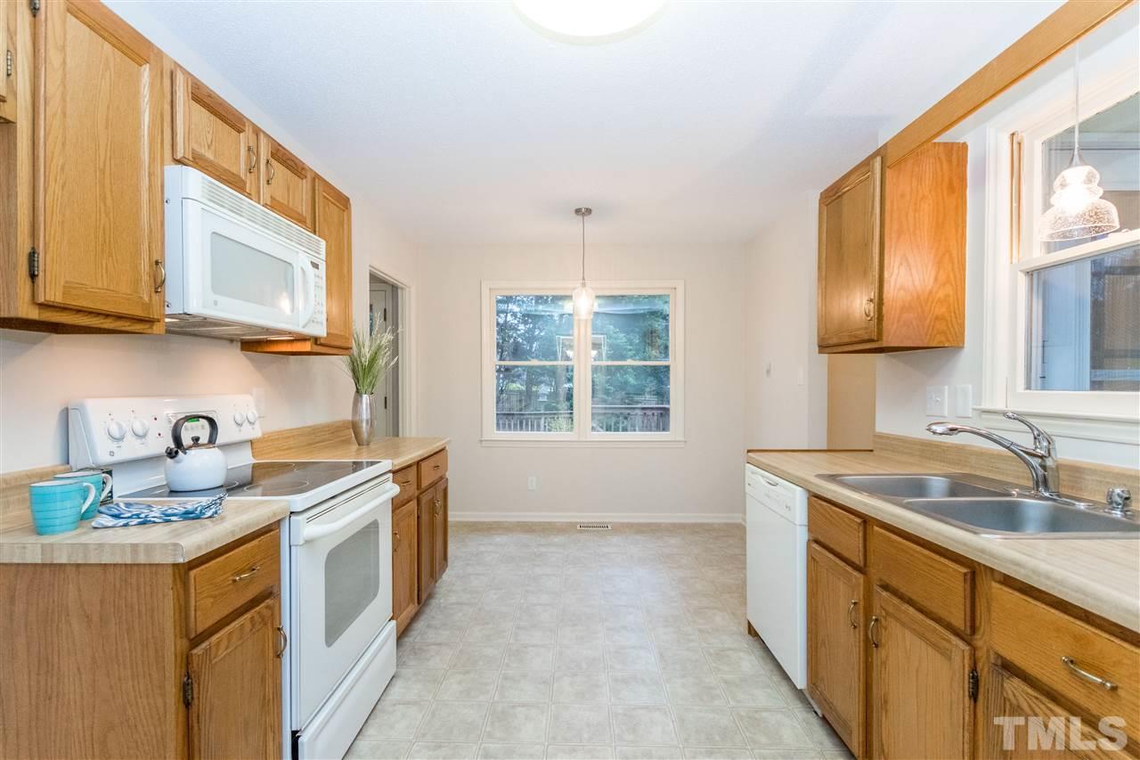 8300 Dunwood Court Raleigh, NC 27613 - Photo 4 of 18 a kitchen that has a sink and a stove in it
