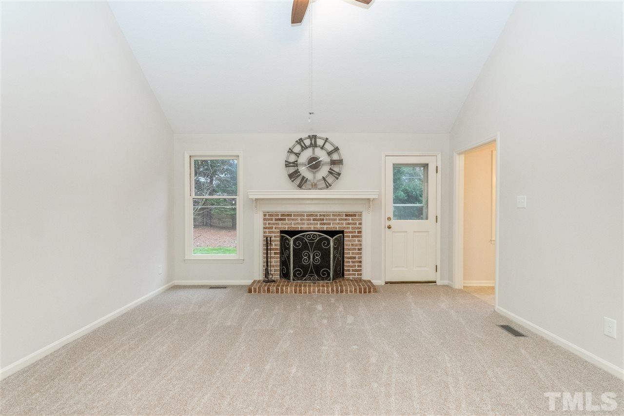 8300 Dunwood Court Raleigh, NC 27613 - Photo 6 of 18 a view of livingroom with fireplace and window