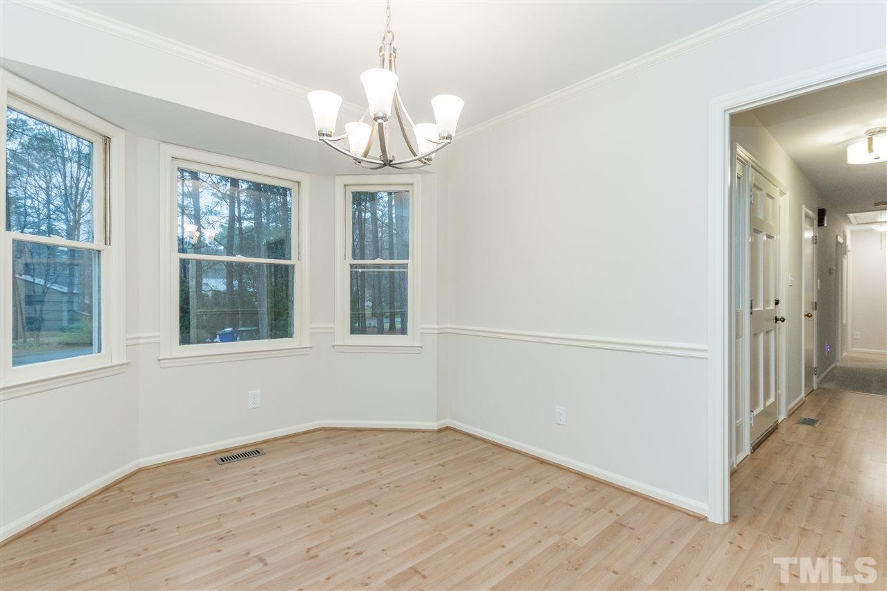 8300 Dunwood Court Raleigh, NC 27613 - Photo 8 of 18 wooden floor in an empty room with a window
