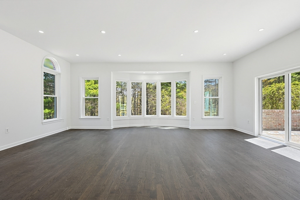 175 Pleasant Street Upton, MA 01568 - Photo 5 of 39 a view of an empty room with wooden floor and a window