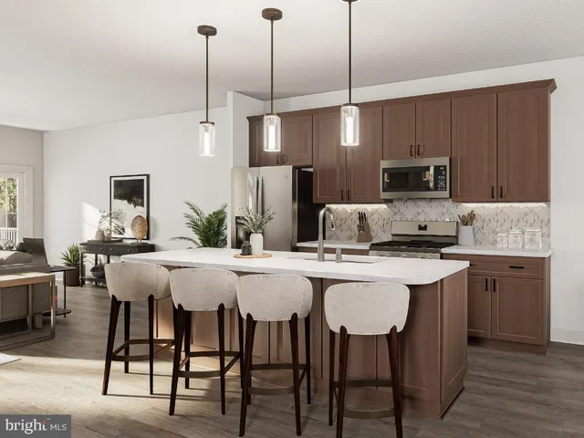 a kitchen with kitchen island granite countertop a dining table chairs and white cabinets
