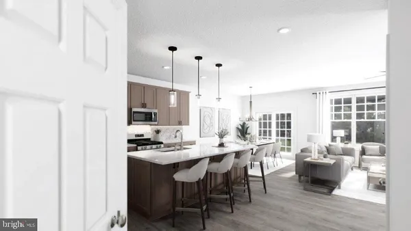 a dining hall with stainless steel appliances kitchen island granite countertop a sink table and chairs