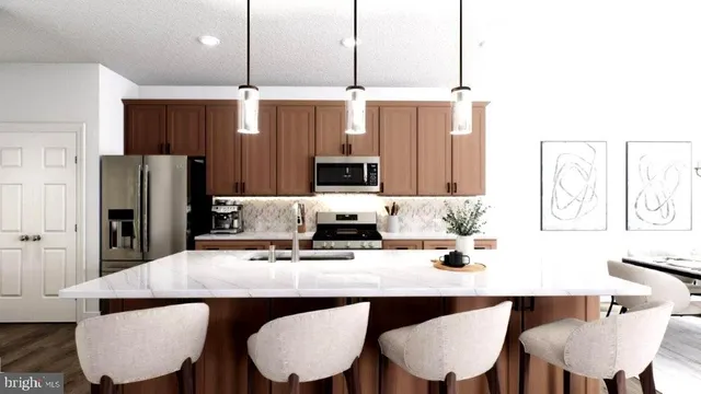 a kitchen with a dining table chairs microwave and refrigerator